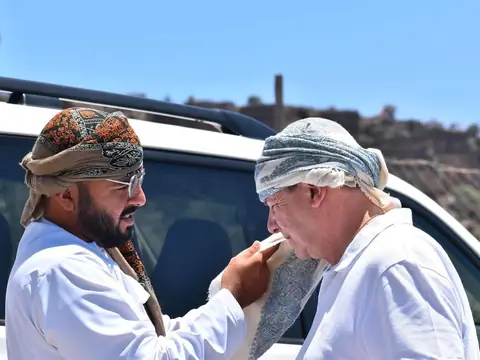 A guest being dressed in an Omani turban